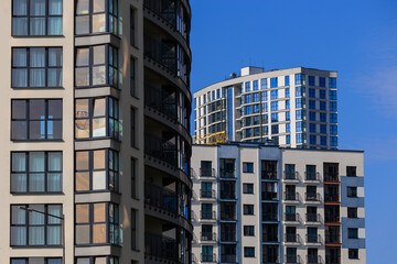 Fototapeta premium City view, modern buildings and skyscrapers against the blue sky.