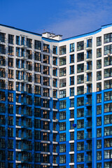 Naklejka premium Modern buildings, walls and windows. City view on a sunny day. 