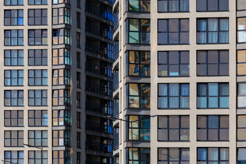 Fototapeta premium Texture of modern buildings, background for design. Elements of architectural decorations of buildings, modern windows, walls and balconies.