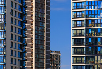 City view, modern buildings and skyscrapers against the blue sky.