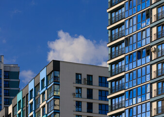 Fototapeta premium City view, modern buildings and skyscrapers against the blue sky.