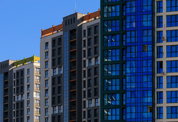 Fototapeta premium City view, modern buildings and skyscrapers against the blue sky.