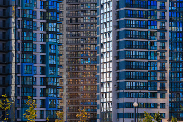 Fototapeta premium Modern buildings, walls and windows. City view on a sunny day. 