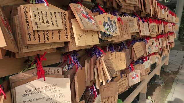 Small wooden plaques to write prayers and wishes (Ema) in Akasaka Hikawa shrine in Tokyo, Japan