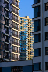 Fototapeta premium City view, modern buildings and skyscrapers against the blue sky.