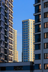 Fototapeta premium City view, modern buildings and skyscrapers against the blue sky.