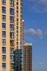 Fototapeta premium City view, modern buildings and skyscrapers against the blue sky.