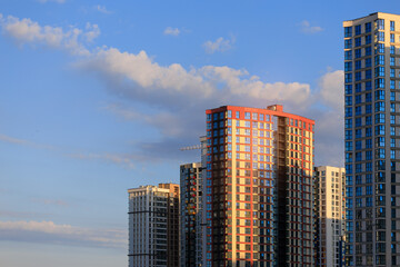 City view, modern buildings and skyscrapers against the blue sky.