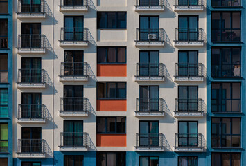 Texture of modern buildings, background for design. Elements of architectural decorations of buildings, modern windows, walls and balconies.