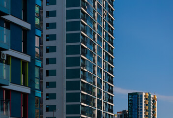 Fototapeta premium City view, modern buildings and skyscrapers against the blue sky.