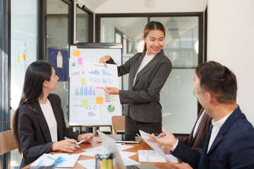A group of Asian businessmen is Meeting to discuss presentations exchange knowledge Presentation about office work