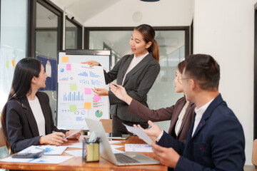 Group of Asian businessmen are sitting in a meeting, talking, exchanging knowledge. Presentation about office work
