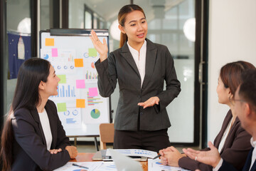 A group of Asian businessmen is Meeting to discuss presentations exchange knowledge Presentation about office work