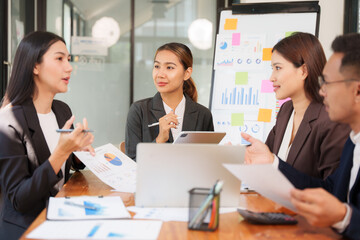 Group of Asian businessmen are sitting in a meeting, talking, exchanging knowledge. Presentation about office work
