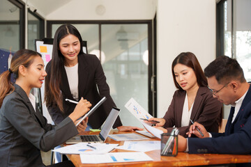 Group of Asian businessmen are sitting in a meeting, talking, exchanging knowledge. Presentation about office work