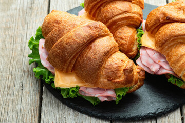 Croissant sandwich with salad ham and cheese . Top view