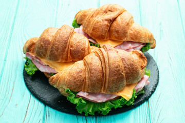 Croissant sandwich with salad ham and cheese . Top view