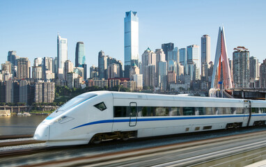 Naklejka premium High-speed rail speeds on Bridges and the modern city skyline of chongqing, China