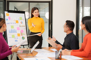 Group of Asian businessmen are sitting in a meeting, talking, exchanging knowledge. Presentation about office work