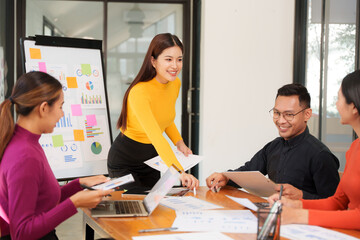 Group of Asian businessmen are sitting in a meeting, talking, exchanging knowledge. Presentation about office work