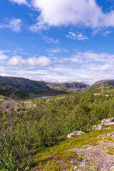 Rocky landscape against the backdrop of clouds and lakes, tundra and rocky mountains, Norway.