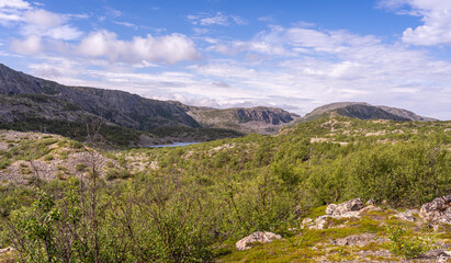 Rocky landscape against the backdrop of clouds and lakes, tundra and rocky mountains, Norway.