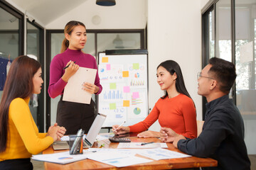Group of Asian businessmen are sitting in a meeting, talking, exchanging knowledge. Presentation about office work