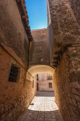 Fototapeta premium Picturesque street with an arch in a rustic village, Medinaceli, Spain