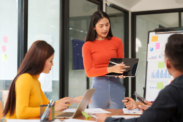 Asian Business Group Chat about graph work Present in meetings, in the office