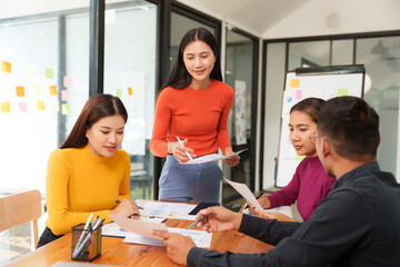 Group of Asian businessmen are sitting in a meeting, talking, exchanging knowledge. Presentation about office work