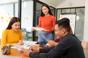 Group of Asian businessmen are sitting in a meeting, talking, exchanging knowledge. Presentation about office work