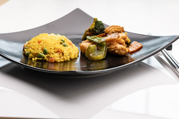 Plate with Chinese Szechuan chicken with scoop of fried rice