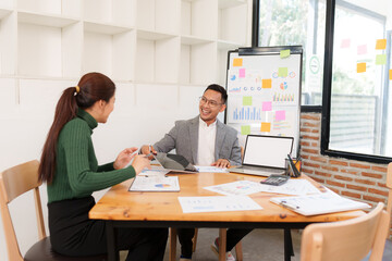 Asian Business Group Chat about graph work Present in meetings, in the office