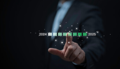 Businessman touches virtual loading screen, symbolizing the transition from 2024 to 2025 shift towards new business opportunities, growth, innovation, future-focused transformation for upcoming year