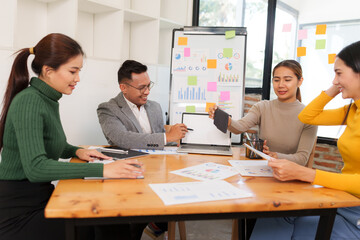 Group of Asian businessmen are sitting in a meeting, talking, exchanging knowledge. Presentation...