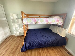 A freshly painted, small bedroom with bunk beds.