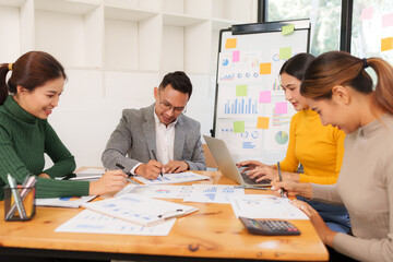 Group of Asian businessmen are sitting in a meeting, talking, exchanging knowledge. Presentation about office work