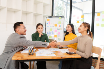 Group of Asian businessmen are sitting in a meeting, talking, exchanging knowledge. Presentation about office work