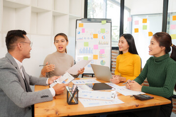 Group of Asian businessmen are sitting in a meeting, talking, exchanging knowledge. Presentation about office work