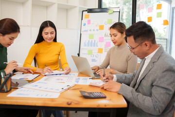 Group of Asian businessmen are sitting in a meeting, talking, exchanging knowledge. Presentation about office work