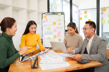 Group of Asian businessmen are sitting in a meeting, talking, exchanging knowledge. Presentation about office work