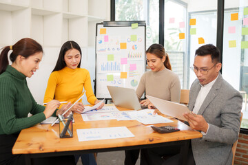 Group of Asian businessmen are sitting in a meeting, talking, exchanging knowledge. Presentation about office work