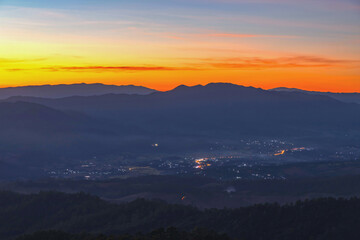 Sunset sky with mountains, Predawn clear sky with orange horizon and blue atmosphere. Smooth orange blue gradient of dawn sky.