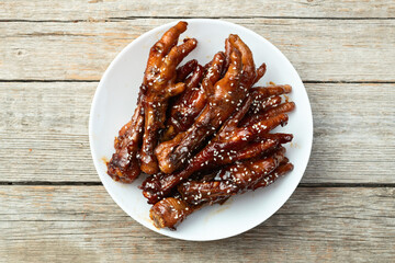 Caramelized korean or Chinese chicken foots ( paws ) with sesame . Top view