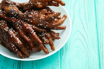Caramelized korean or Chinese chicken foots ( paws ) with sesame . Top view