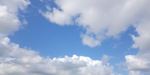 Naklejka premium Fluffy white clouds against a vibrant blue sky, atmosphere, cloudscape