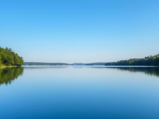 Clear crystal water of a serene lake reflecting the blue sky and lush green trees, serene, nature