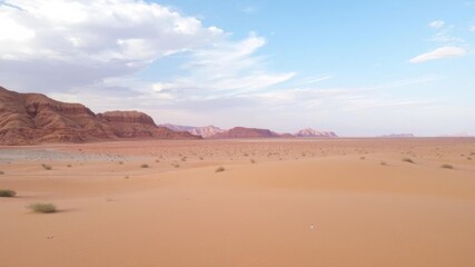 Endless sand dunes stretching into the horizon under a bright blue sky, harsh, heat