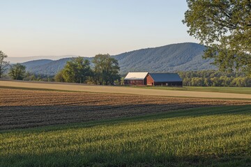 Picturesque rural landscape with red barn and rolling hills