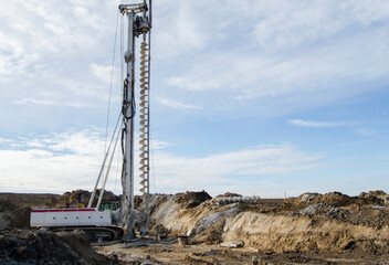 Building activity on contruction site.Drilling machine.Wind turbine construction.
Excavator and other construction equipment.